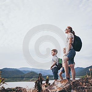 Happy family standing near the lake at the day time