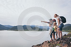 Happy family standing near the lake at the day time