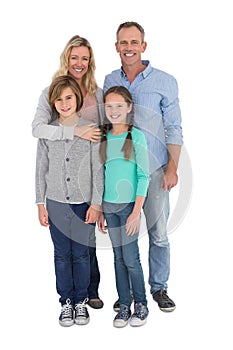 Happy family standing and smiling at camera