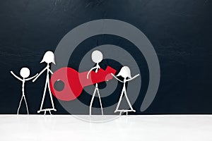 Happy family stick figure carrying together a big red key in dark background with copy space. Buying and owning a new house, car.