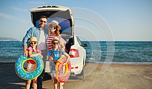 Happy   family  in summer auto journey travel by car on beach