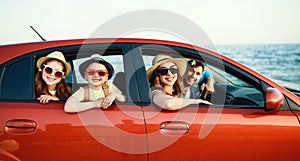 Happy family  in summer auto journey travel by car on beach