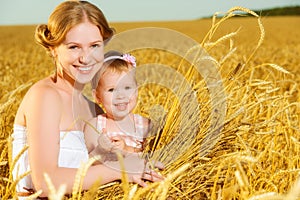 Happy family in summer nature. Mother and baby daughter in the w