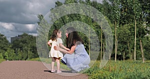 Happy family in summer park, Mother and daughter walking in Park and enjoying time together.