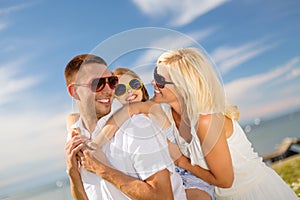 Happy family in sunglasses having fun outdoors