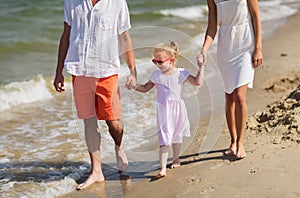 Happy family in sunglasses on summer beach