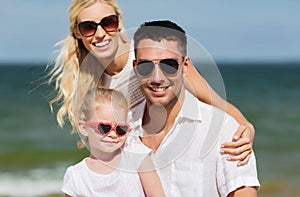 Happy family in sunglasses on summer beach