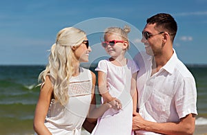 Happy family in sunglasses on summer beach