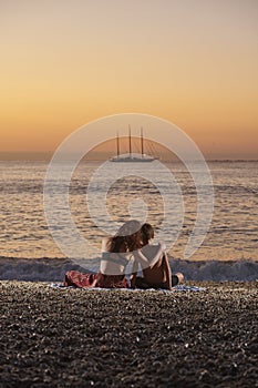 Happy family at sunrise on a summer day at the beach