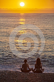 Happy family at sunrise on a summer day at the beach