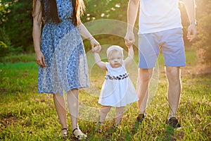 Happy family at sunset. Father, mother and child daughter having fun and playing.