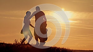 Happy family on sunset silhouette