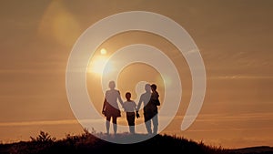 Happy family on sunset silhouette