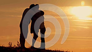 Happy family on sunset silhouette