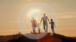 Happy family on sunset silhouette