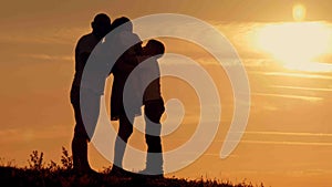 Happy family on sunset silhouette