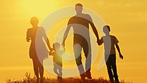 Happy family at sunset silhouette