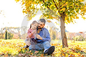 Happy family at sunset walking in the park in autumn