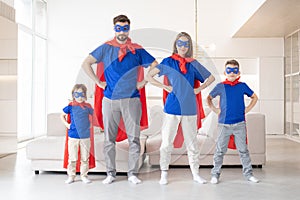 Happy family in superhero costumes