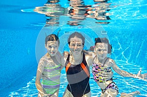 Happy family swim underwater in pool