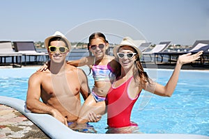 Happy family in swimming pool on day