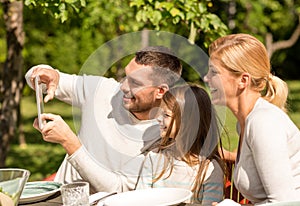 Happy family with tablet pc outdoors