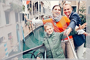 Happy family take a self photo on the one of bridges in Venice