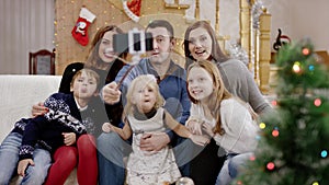 Happy family taking selfie at the christmas party