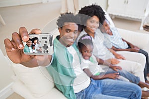 Happy family taking a selfie on the couch