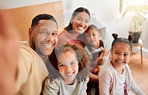 Happy family taking selfie, having fun, relaxing and bonding in living room at home. Smiling, carefree parents enjoying