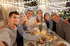 Happy family taking selfie at tea party at home