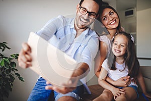 Happy family taking selfie in their house