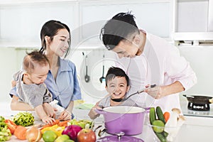 Happy family tasting the soup in kitchen