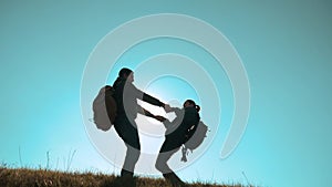 Happy family teamwork business travel concept. Couple silhouette holding hands are spinning with backpacks happiness