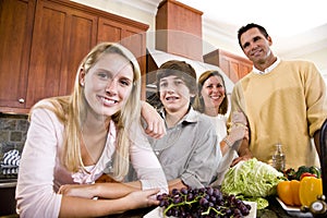 Happy family with teenage children in kitchen