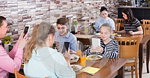 Happy family with teenagers addicted to theirs smartphones