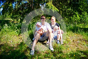 Happy family with three children outdoors