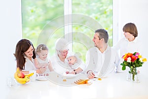 Happy family with three children visiting grandmother