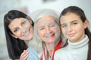 Happy family three generations smiling and looking at camera