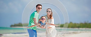 Happy family of three having fun together on the beach