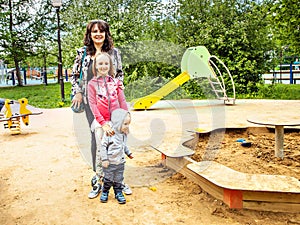 Happy family of three moms with a seven year old daughter and two year old son for a walk.