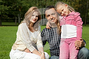 Happy family of three outdoors