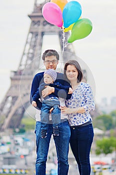 Happy family of three in Paris near the Eiffel tower