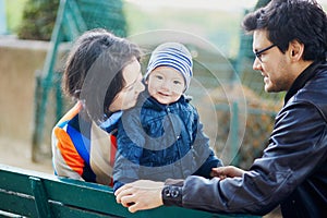 Happy family of three in Paris near the Eiffel tower