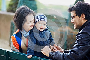 Happy family of three in Paris near the Eiffel tower