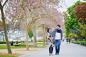 Happy family of three in Paris on a spring day