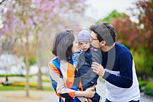 Happy family of three in Paris on a spring day