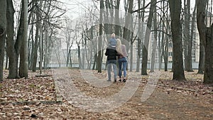 Happy family of three walking in the spring Park