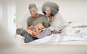Happy, family tickle and bedroom with laughing with bonding of father, mother and child smile. Home, mom and dad