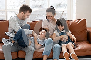 Happy family tickle children and having good time.